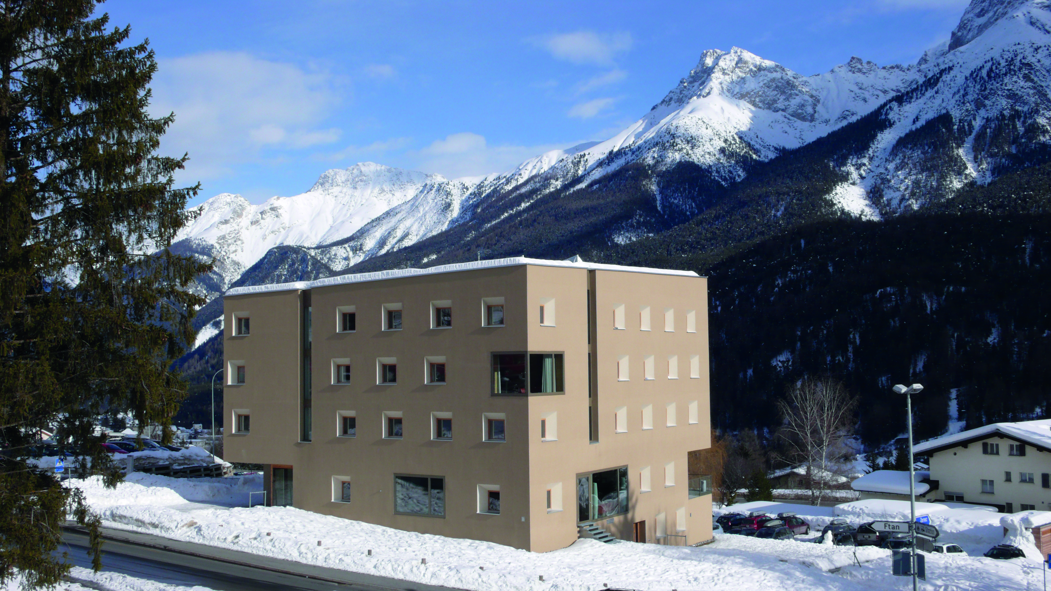 Outside view winter and house with a view on mountains Scuol Youth Hostel